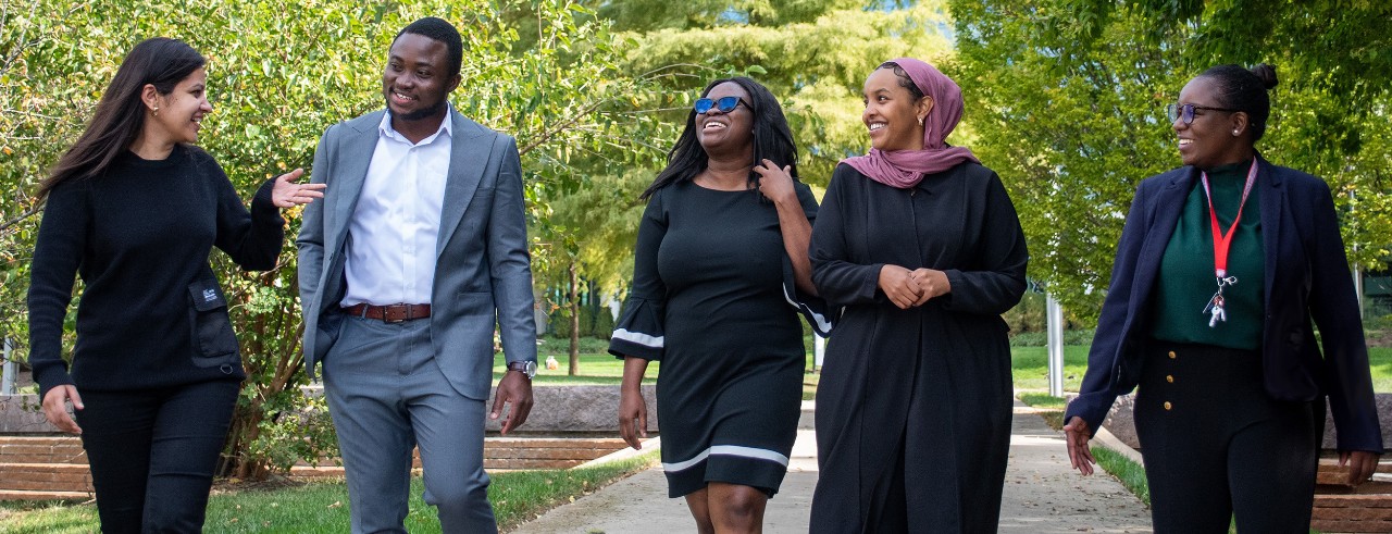 University of Cincinnati international students walk down a path on the University of Cincinnati campus.