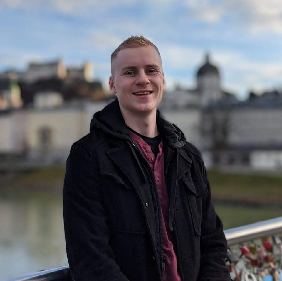 Beau Becker stands in front of a castle in Germany.